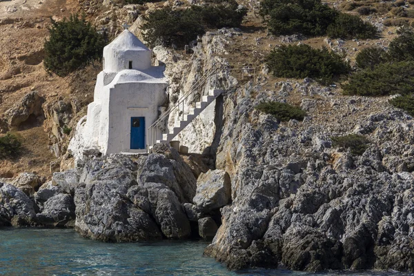 Tiny chapel on rock at the water, Greece