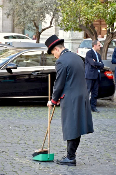 Employee sweeps the street in Rome