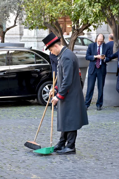 Employee sweeps the street in Rome