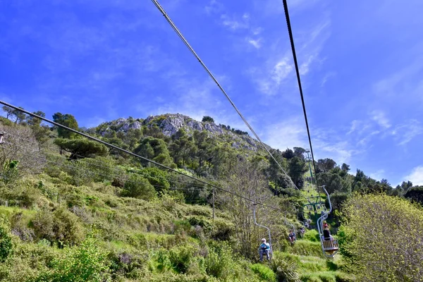 Tourists riding up the mountain lift to get to the top of Anacapri