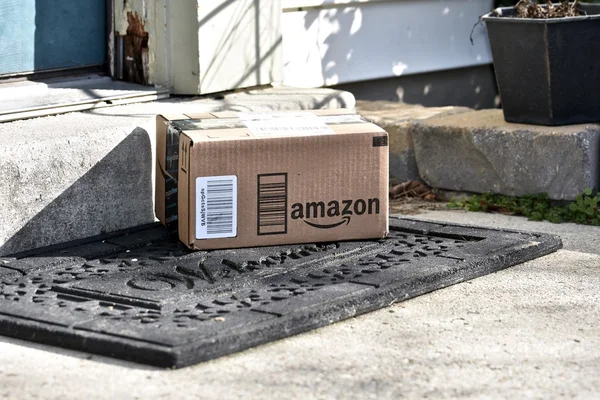 Amazon boxes delivered to the front door of a home