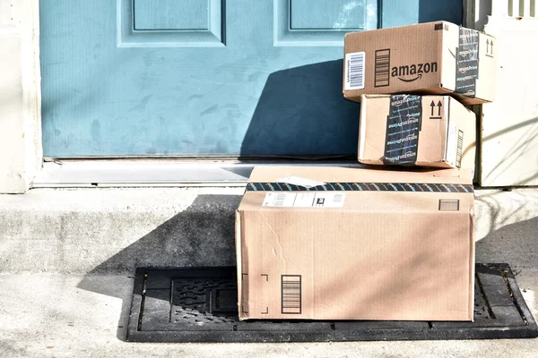 Amazon boxes delivered to the front door of a home