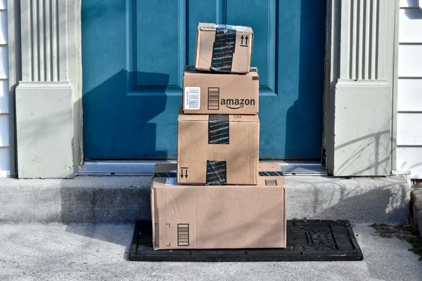 Amazon boxes delivered to the front door of a home