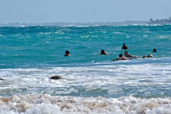 Surfers riding waves on Condado beach