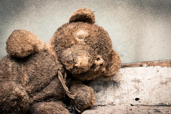 Old teddy bear abandoned piles of paper,black and white tone