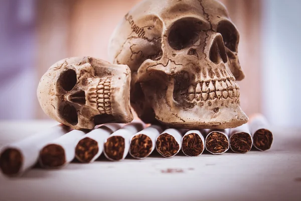 No smoke concept,Skull Tobacco Cigarettes on wooden ,vintage