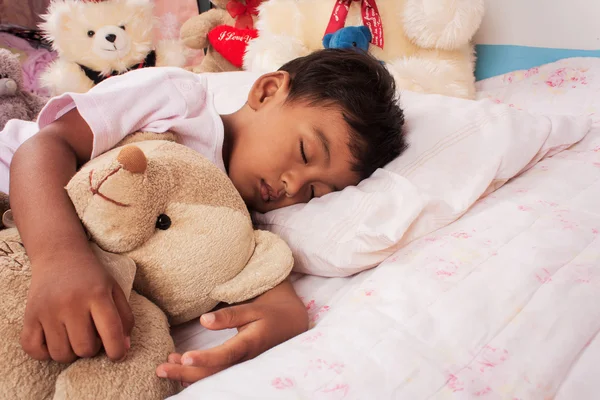 A little asian boy sleep with teddy bear