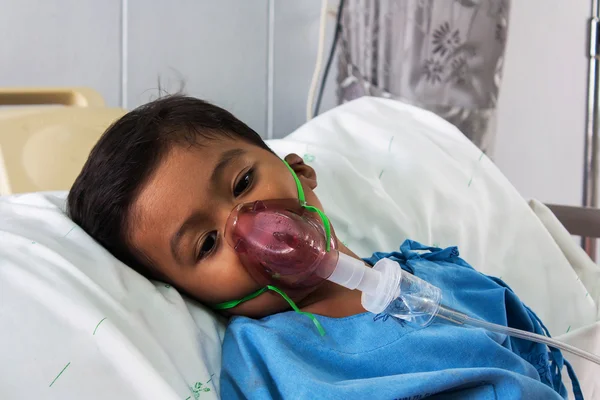 Boy sick in inhaler mask for kid, the hopital