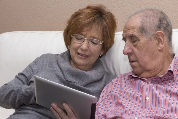 Happy senior couple with tablet pc computer