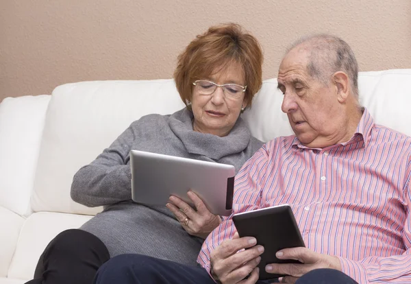 Happy senior couple with tablet pc computer