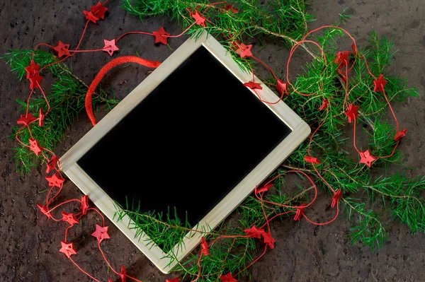 Greeting card christmas decoration with red stars and black chalkboard