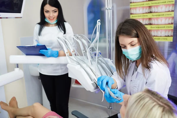 Treatment of the patient girl in the dental clinic