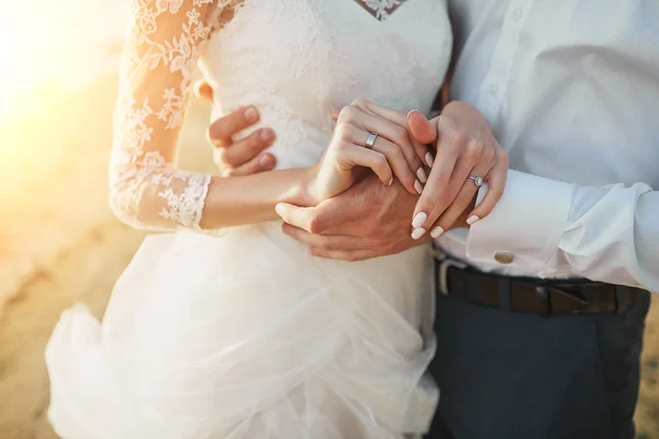 Just married couple running on a sandy beach