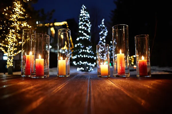 Beautiful candles with lights on wooden floor