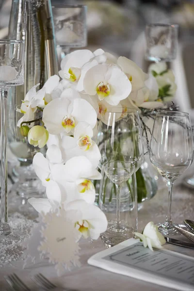 Wedding reception with floral arrangement of white orchids