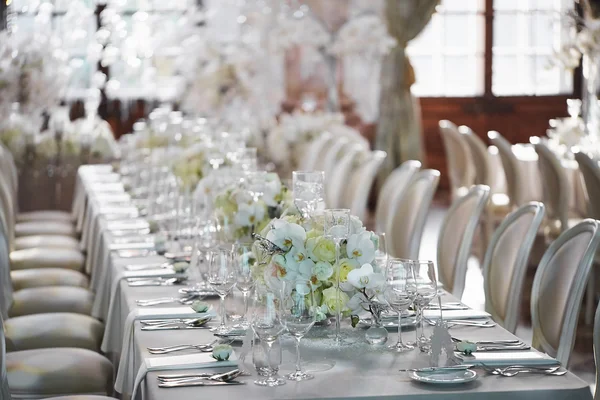 Wedding reception with floral arrangement of white orchids