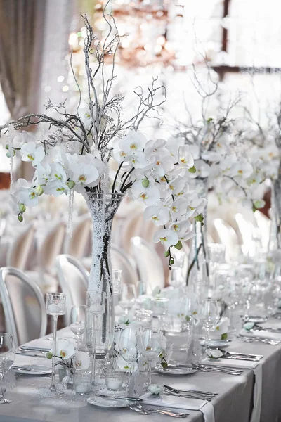 Wedding reception with floral arrangement of white orchids