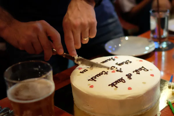 Man cutting birthday cake