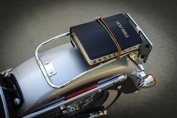 Motorcycle With Holy Bible Strapped to Luggage Rack