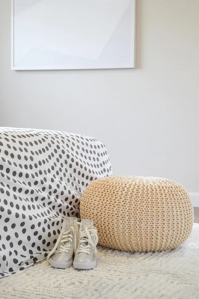 Girl shoes on white carpet in bedroom interior design with polka dot bed sheet