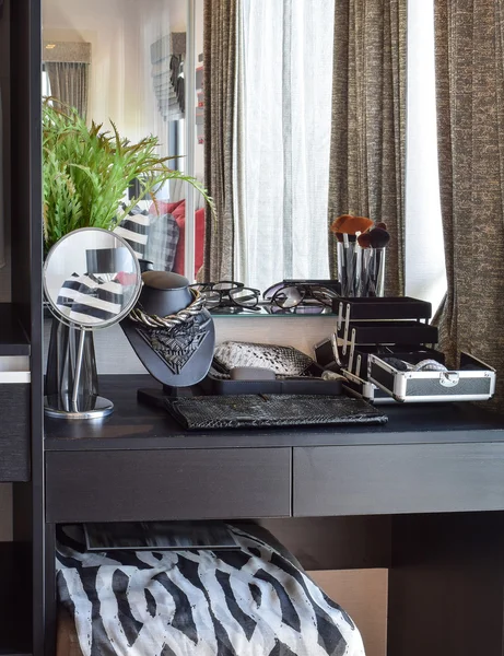Black wooden dressing table with accessories at home