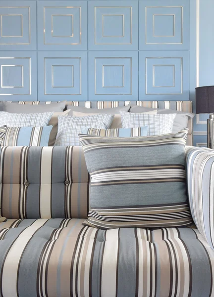 Light blue and light brown striped sofa set with classic blue wall