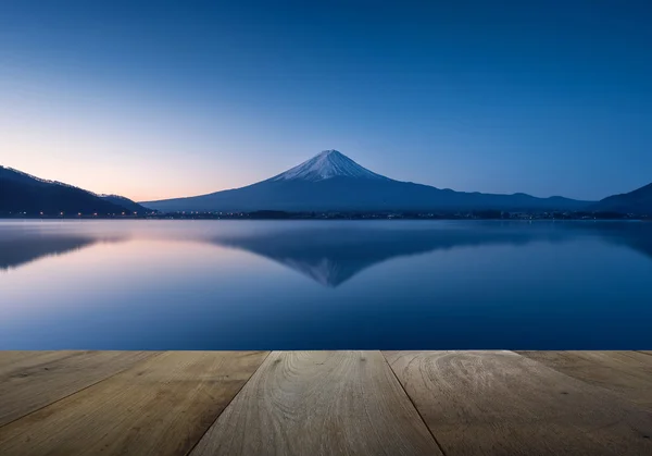 Wooden terrace and mountain fuji with reflection at lake kawaguchiko in the morning