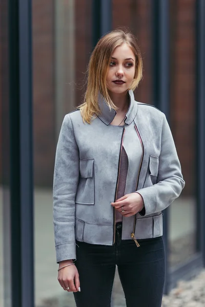 Young woman standing in front of office buildings