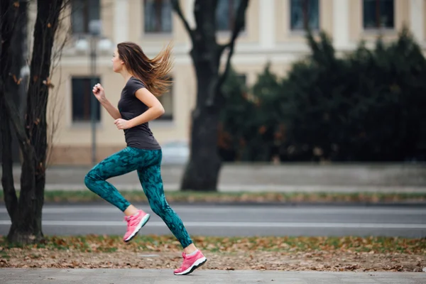 Young sport girl running in the park