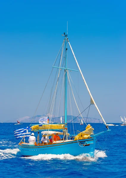 People on a Greek classic wooden sailing boat