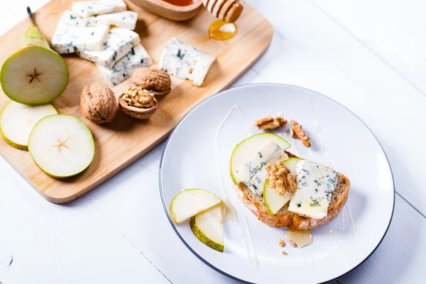 Cheese with slices of pear, nuts and honey