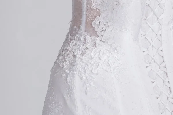 Detail of luxury expensive wedding dress. Lace, satin ribbons, expensive fabric.