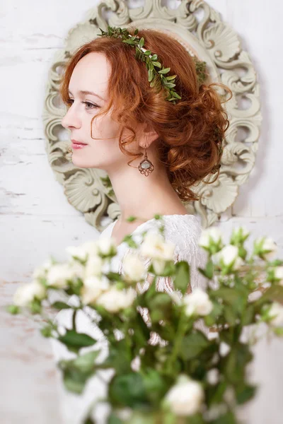 Beautiful young bride in a green wreath.