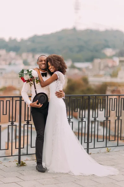 Beautiful african wedding couple standing on the balcony on their wedding day