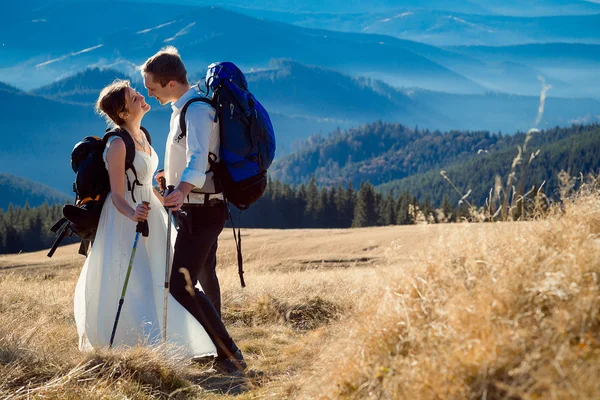 Charming tourist wedding couple hugs on the top of mountain. Honeymoon in Alps