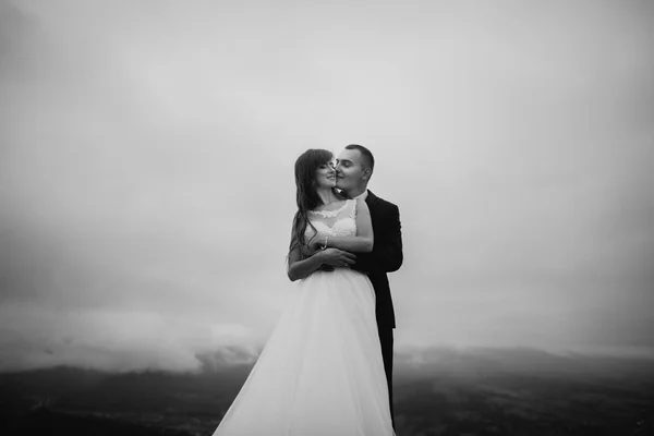 Loving wedding couple at the moment before kissingoutdoor.