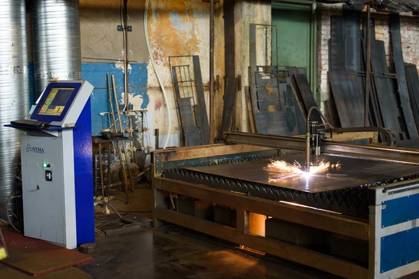 Bright orange sparks during metal grinding in heavy industry plant