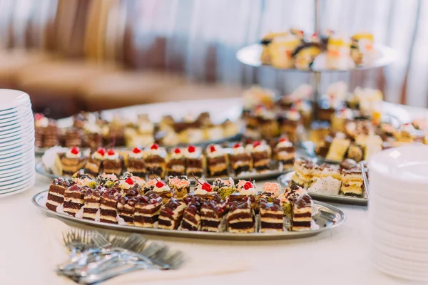 Close-up view collection of delicious assorted mini dessert standing on a table in restaurant