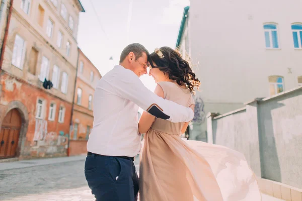 Beautiful bridal couple dancing at sunset on the streets of old city