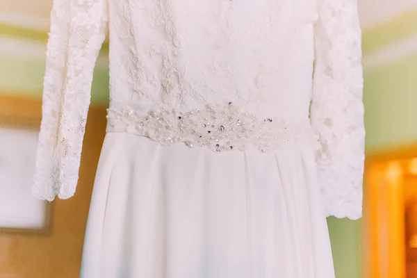 Close up of the hanging in hotel room wedding dress detail