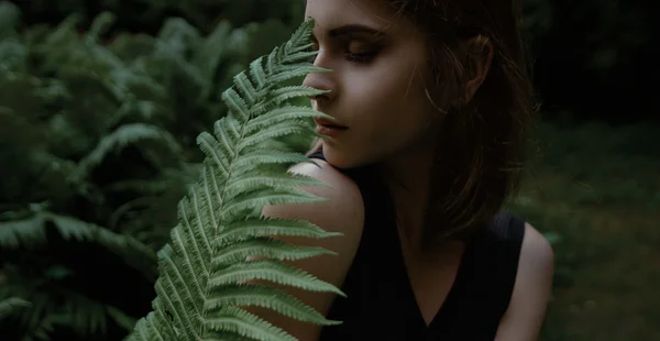 Beautiful face of young woman with fresh health skin posing on the nature