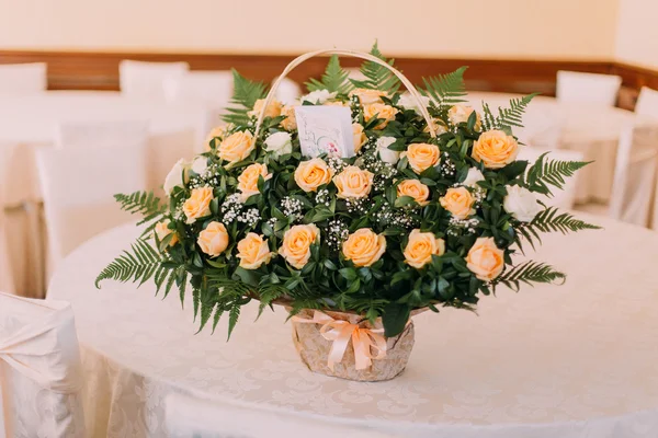 Bouquet of beautiful roses on a white wooden table. Wedding day