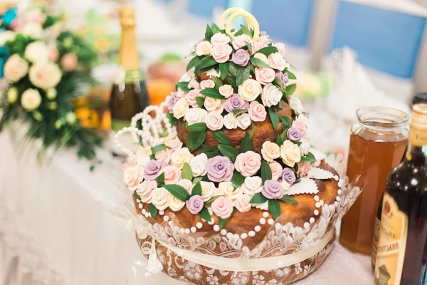 Beautifully decorated traditional wedding bread on catering table