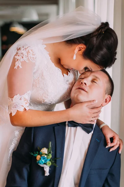 Portrait of happy newlyweds embracing after the ceremony