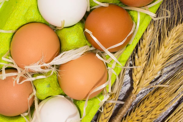 Yellow and white eggs in a box