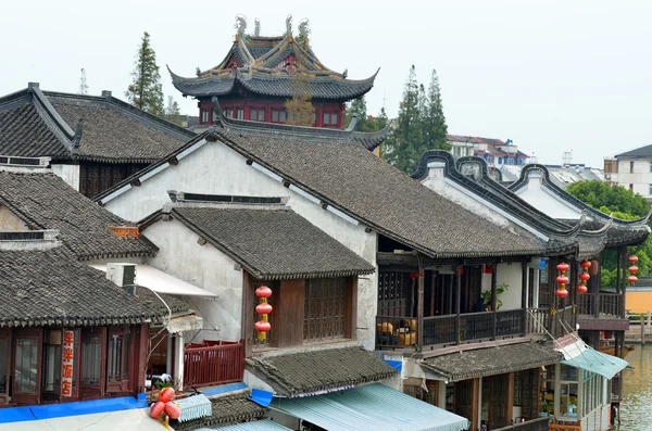 Old village by river in Shanghai with boat