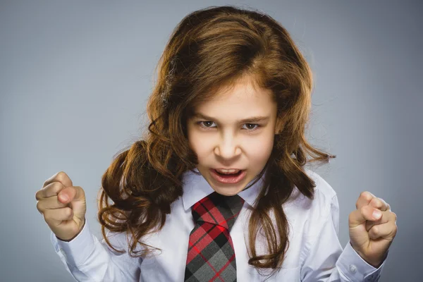 Portrait of angry girl with hands up yelling isolated on gray background. Negative human emotion, facial expression. Closeup