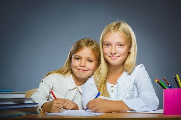 School concept. Closeup portrait successful happy girls drawing pencil