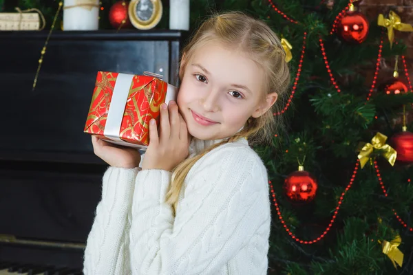 Happy girl holding gifts. Waiting for Christmas. Celebration. New Year.