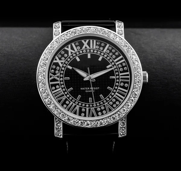 Closeup of the luxurious lady\'s watch a black background